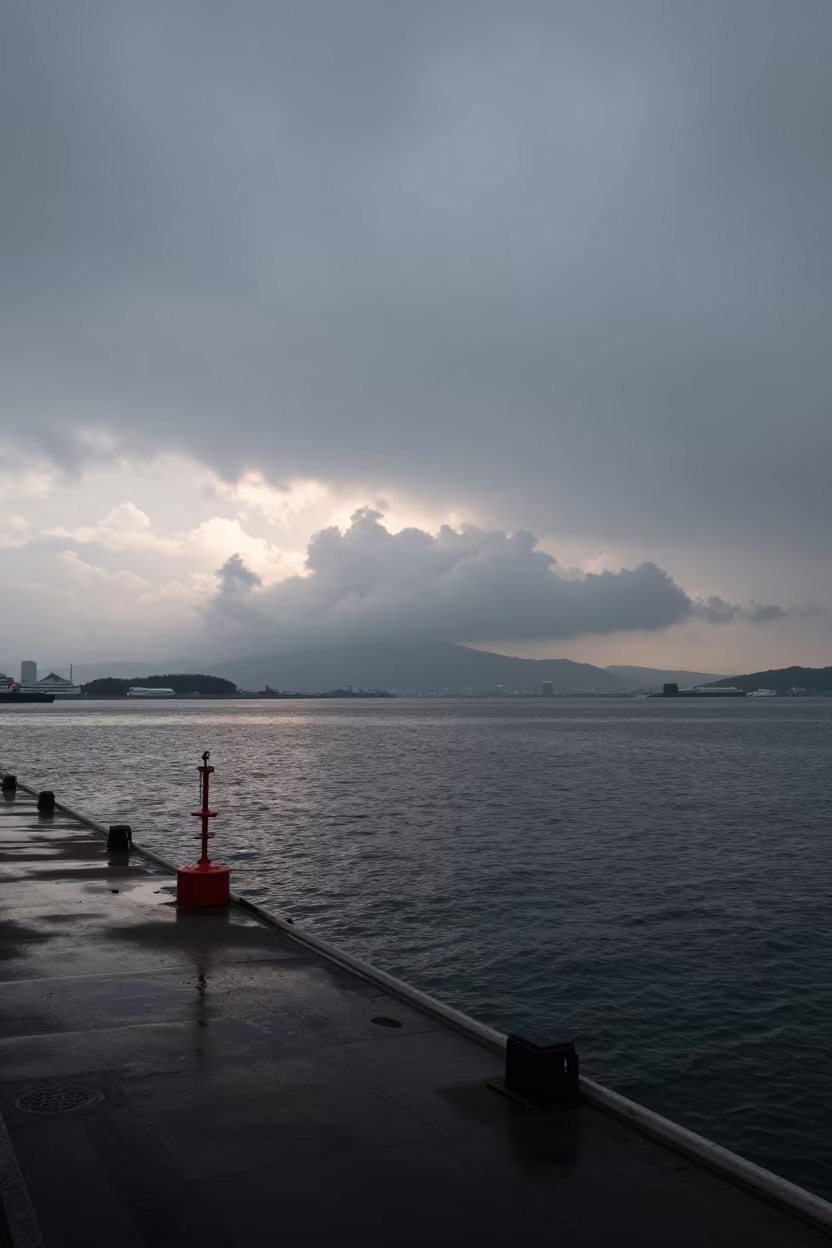 Grey Overcast Morning Over Fukuoka Harbor in over a horizon of stacked thunderheads near Fukuoka