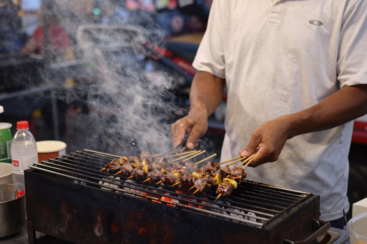 Grilling Satay in Phuket at The Early Evening Light in in Phuket, Thailand