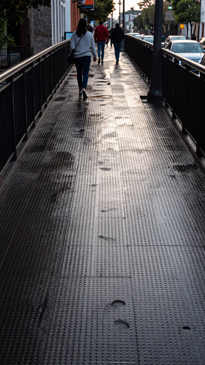 Guadalajara Mexico Late Morning Pedestrian Overpass Perforated Metal Wet Footsteps Realistic 1970s Street Scene in in Guadalajara, Mexico