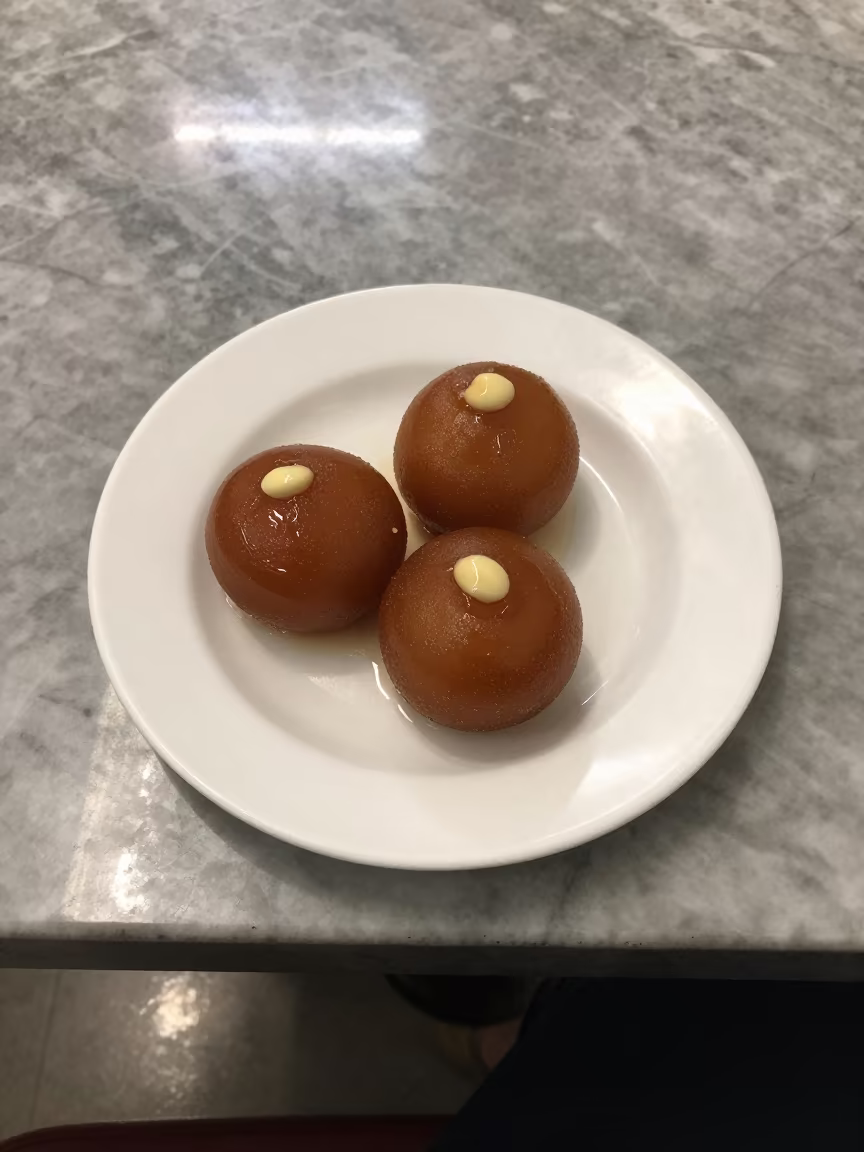 Gulab Jamun Syrup Plate Night Cafe in on a marble cafe table in Cox's Bazar