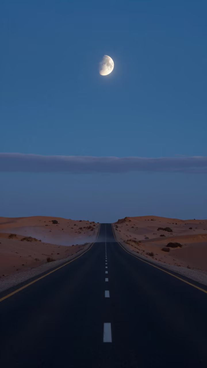 Half Moon Over Desert Highway Tunisia Twilight in from a dune-backed overlook in clear desert air in Tunisia