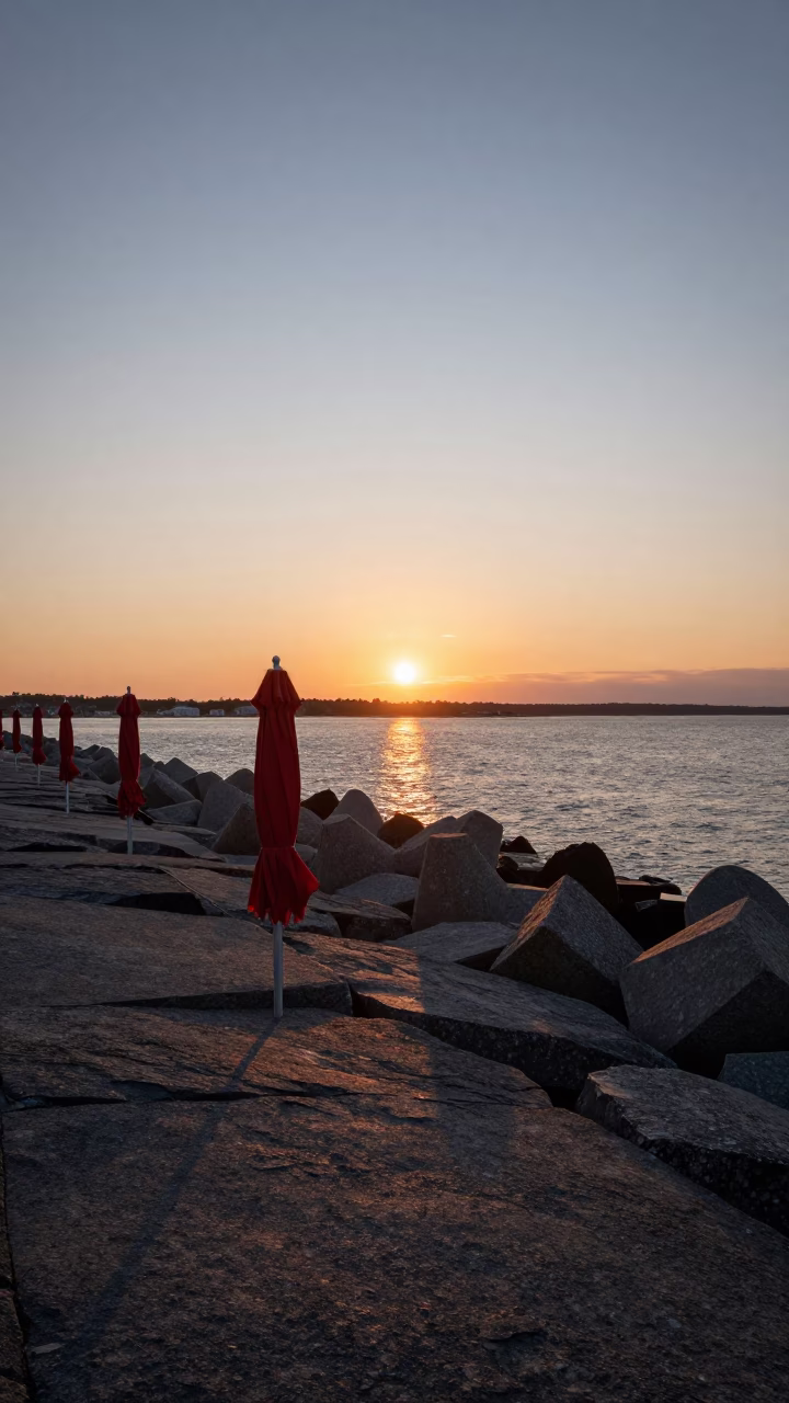 Halifax Harbor Sunset with Umbrellas and Breakwater Tetrapods in Nova Scotia in in Halifax, Nova Scotia, Canada