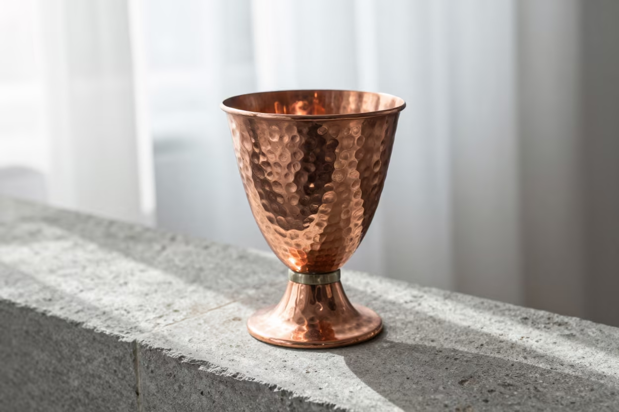 Hammered Copper Goblet on Stone Ledge in on a stone ledge in Gandhinagar