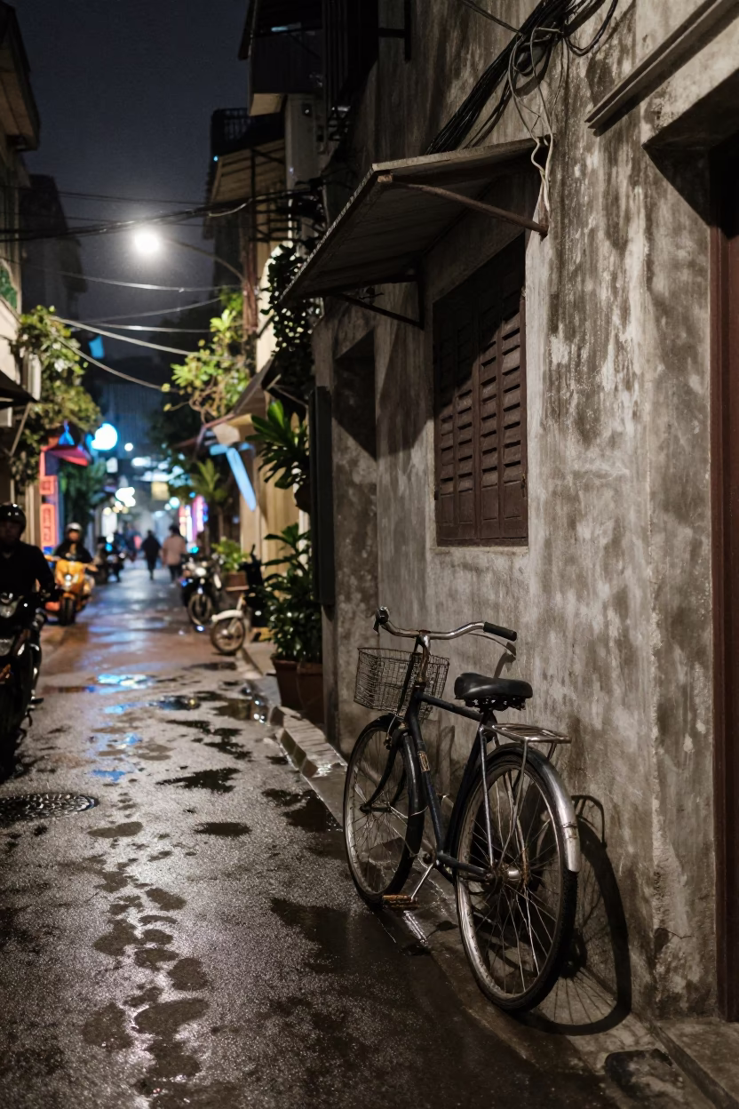 Hanoi Night Street Scene with Bicycle and Lived-In Interior Glimpse in in Hanoi, Vietnam