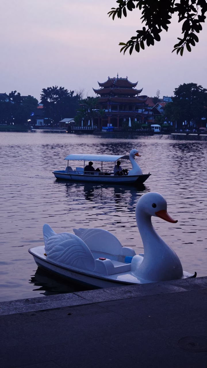Hanoi Vietnam pre-dawn street scene with swan pedal boat on Hoan Kiem Lake in in Hanoi, Vietnam
