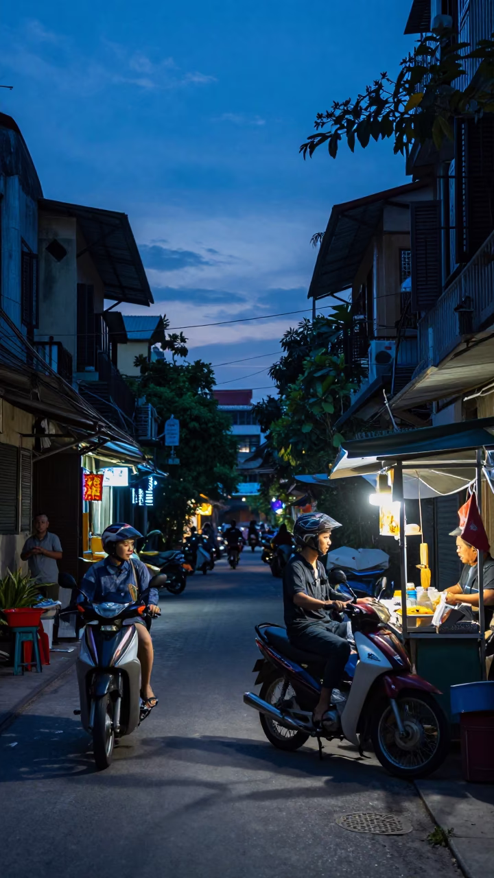 Hanoi Vietnam Street Scene at Indigo Twilight with Motorbike and Street Food Vendor in in Hanoi, Vietnam