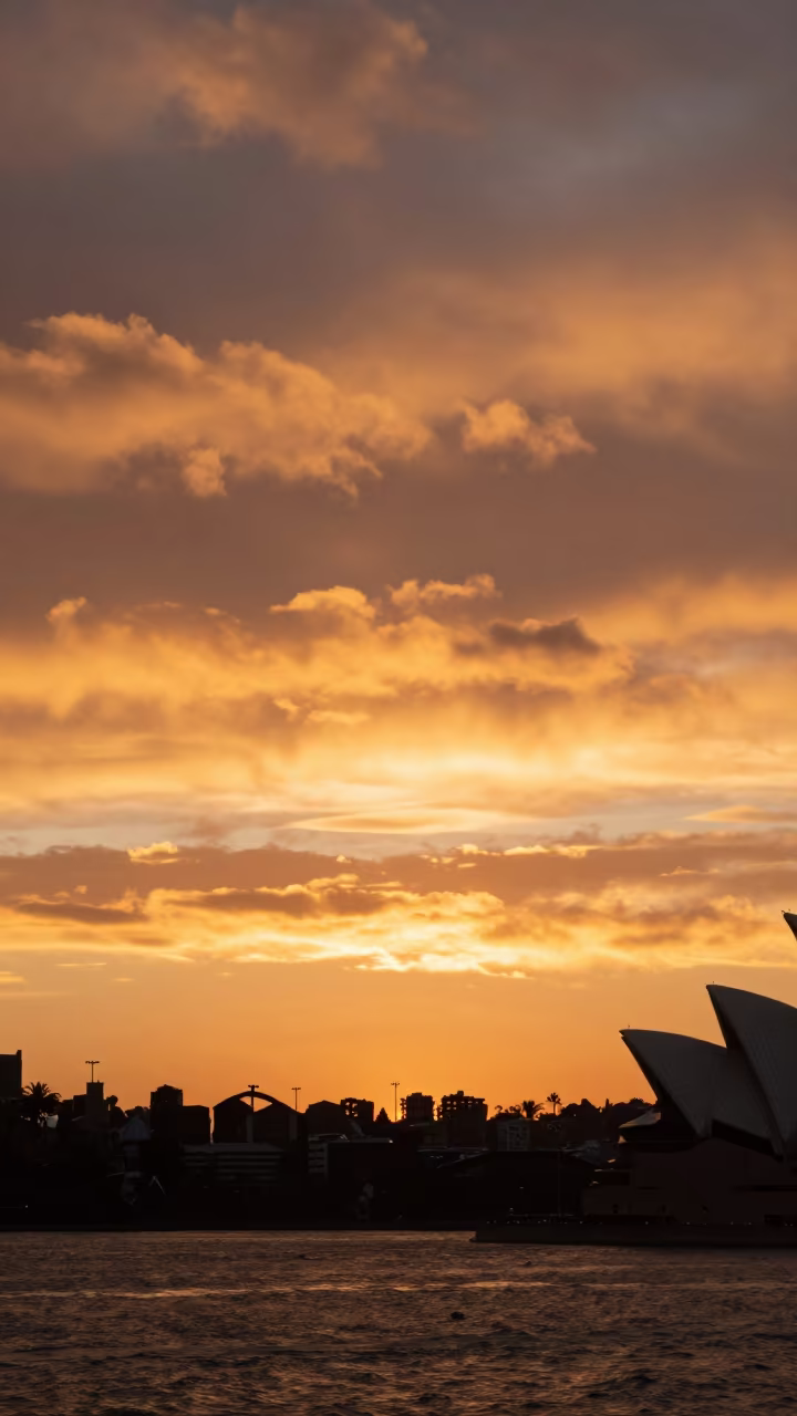 Heat Shimmer Over Sydney Harbor Sunset in beneath fast-moving cloud bands near Sydney