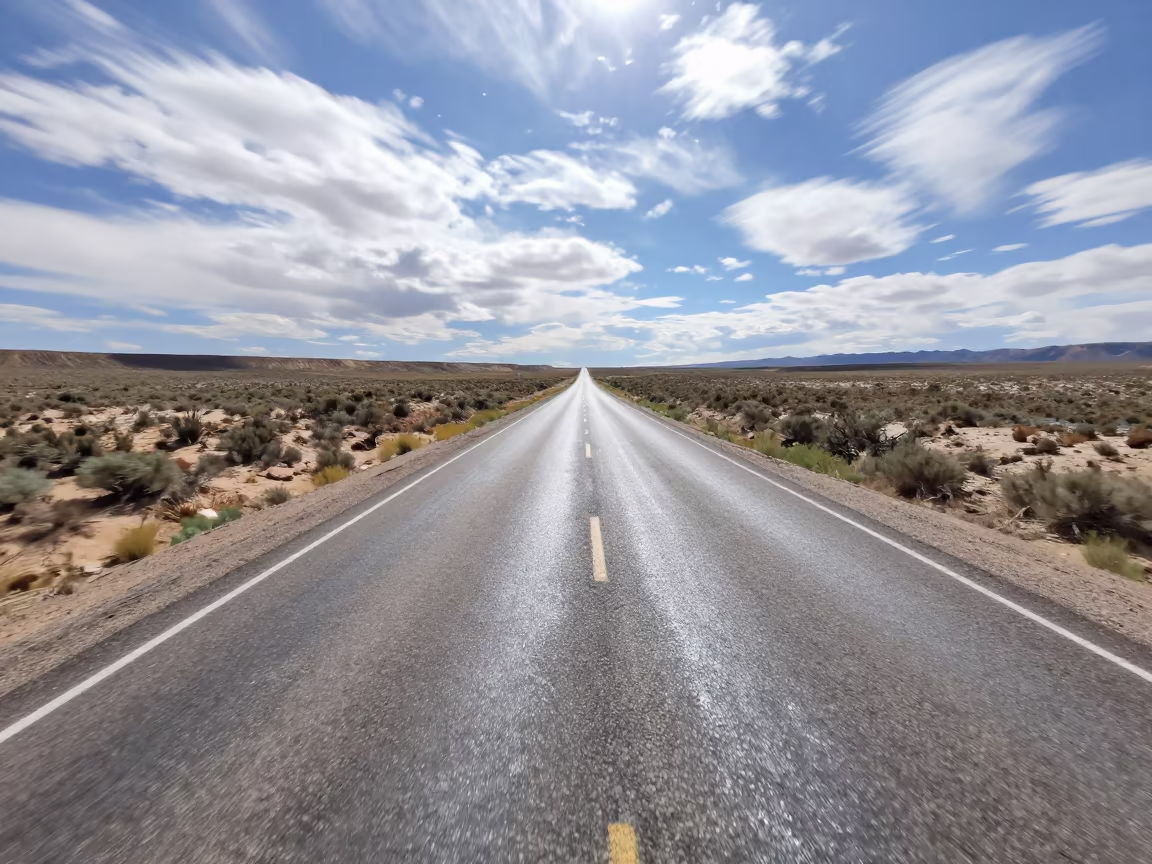 Heat Shimmer Distorts Utah Desert Road in beneath fast-moving cloud bands in Utah