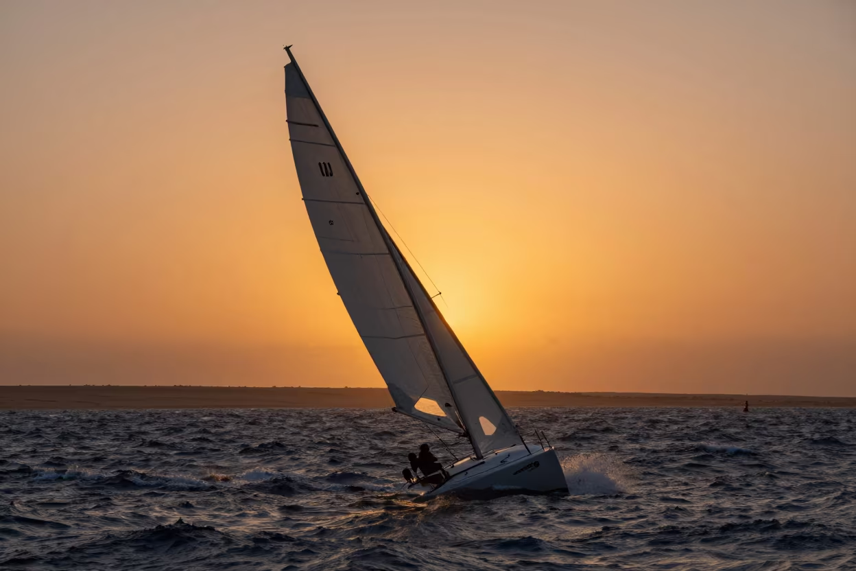 Heeled Sailboat in Orange Sunset Light Near Taourirt in near Taourirt
