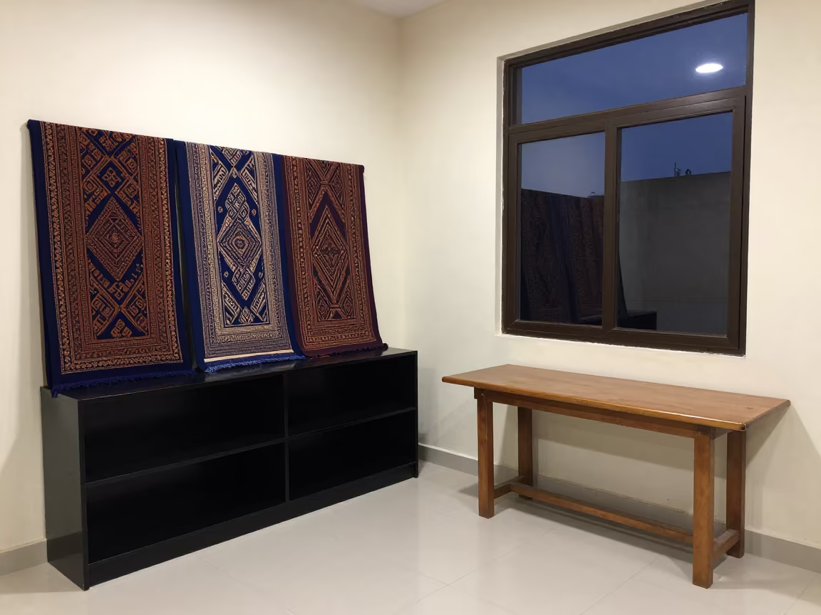 Heritage Textiles on Lacquered Shelf at Blue Hour in on a lacquered display shelf in Al-Fashir