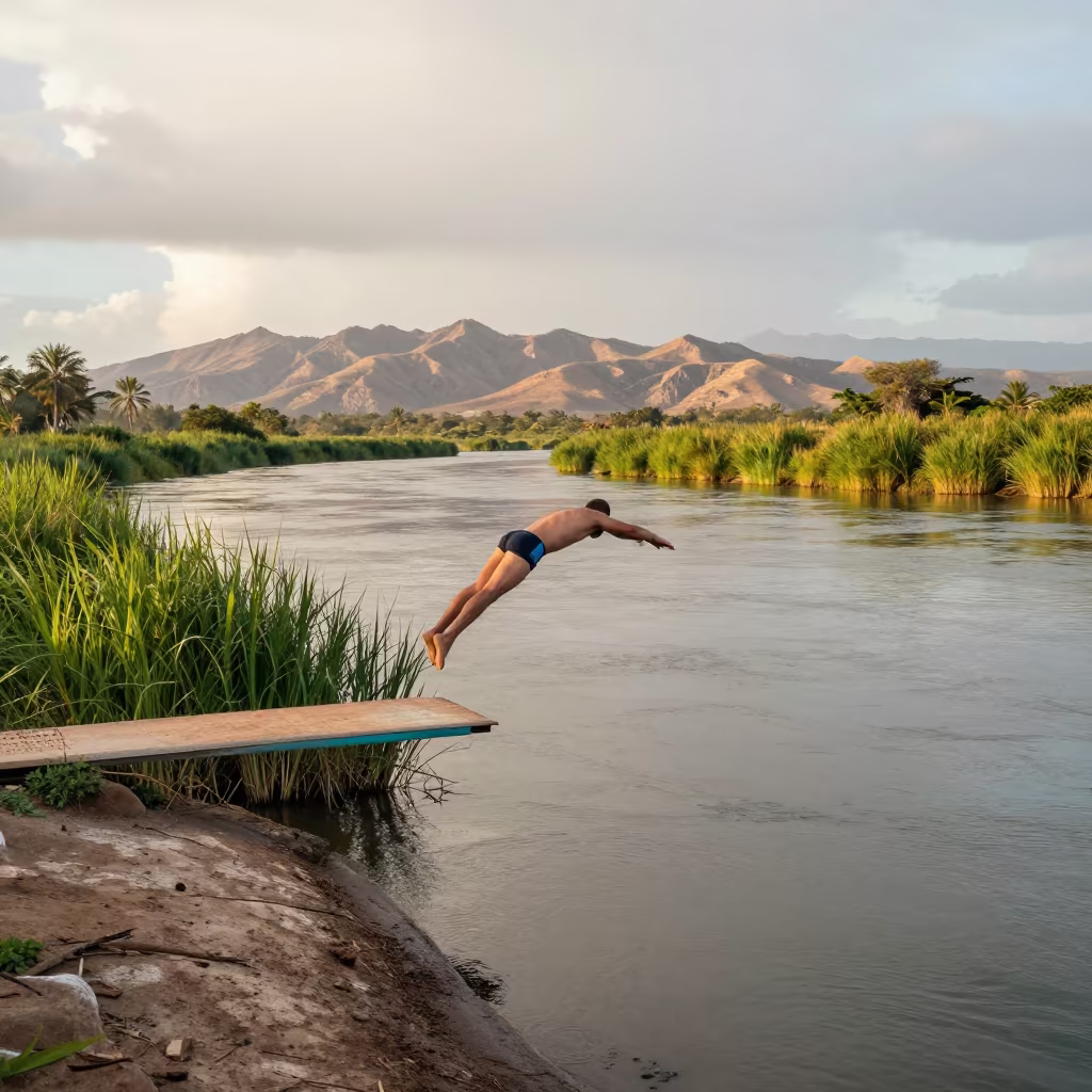 High Diver Pike Jump Over Zanzibar River After Storm in by a riverbank near Zanzibar