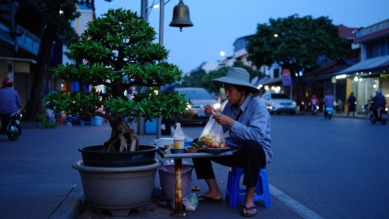 Ho Chi Minh City Street Vendor Evening Meal with Bonsai and Bell in in Ho Chi Minh City, Vietnam