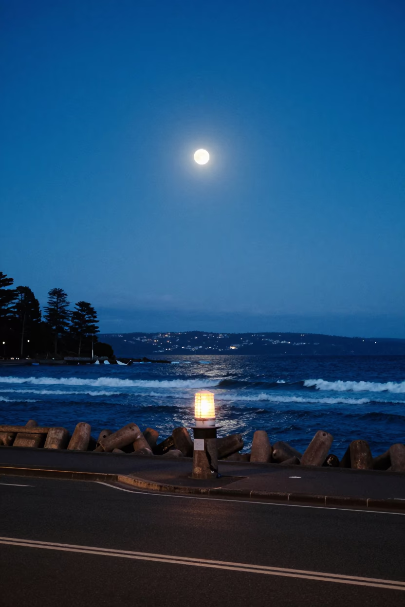 Hobart Tasmania Early Evening Street Scene with Moonlit Surf and Breakwater Beacon in in Hobart, Tasmania, Australia