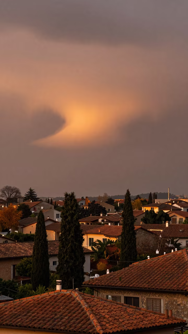 Hole Punch Cloud Over Italian Suburb in beneath fast-moving cloud bands in Italy