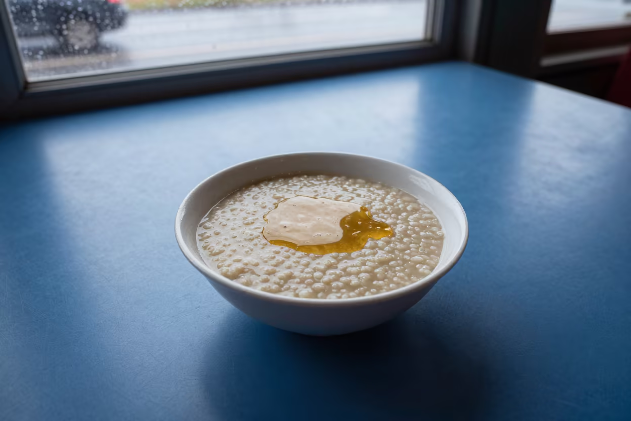 Honey Drizzled Porridge Dawn Huambo Diner in at a roadside diner table in Huambo