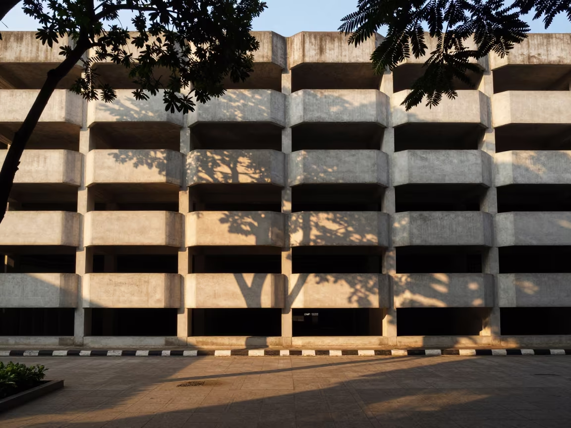 Honeycomb Facade Dappled in Monsoon Light in across a formal civic plaza in Charoen Krung, Bangkok