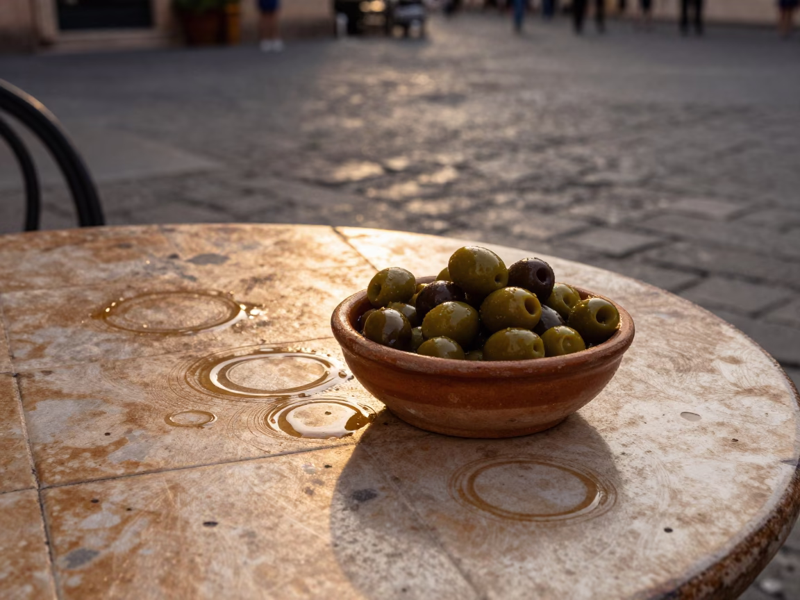 Honeyed Evening Light Illuminates Olives and Water Rings on Palermo Tile in in Palermo, Italy