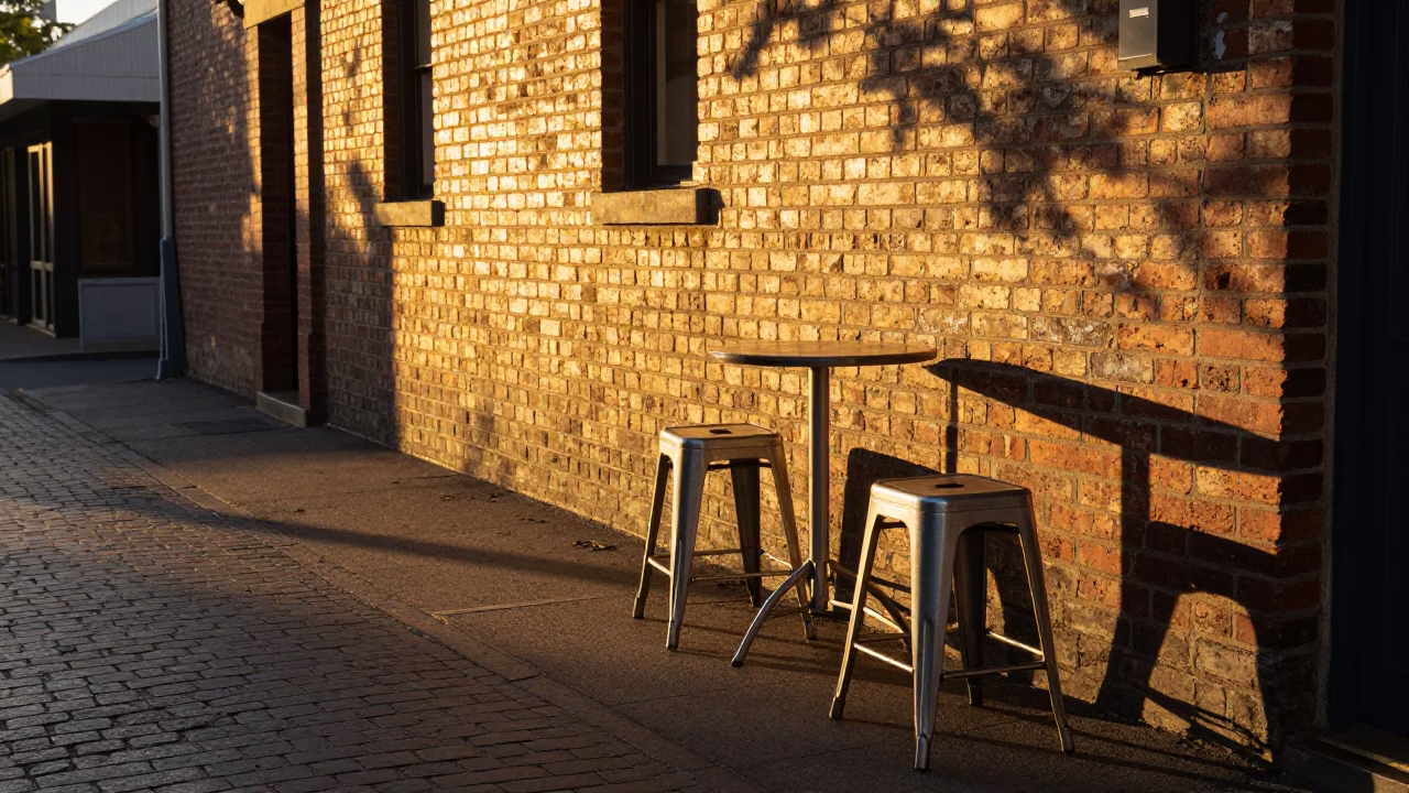 Honeyed Evening Light on Adelaide Street with Metal Stools and Clay Pot in in Adelaide, South Australia, Australia