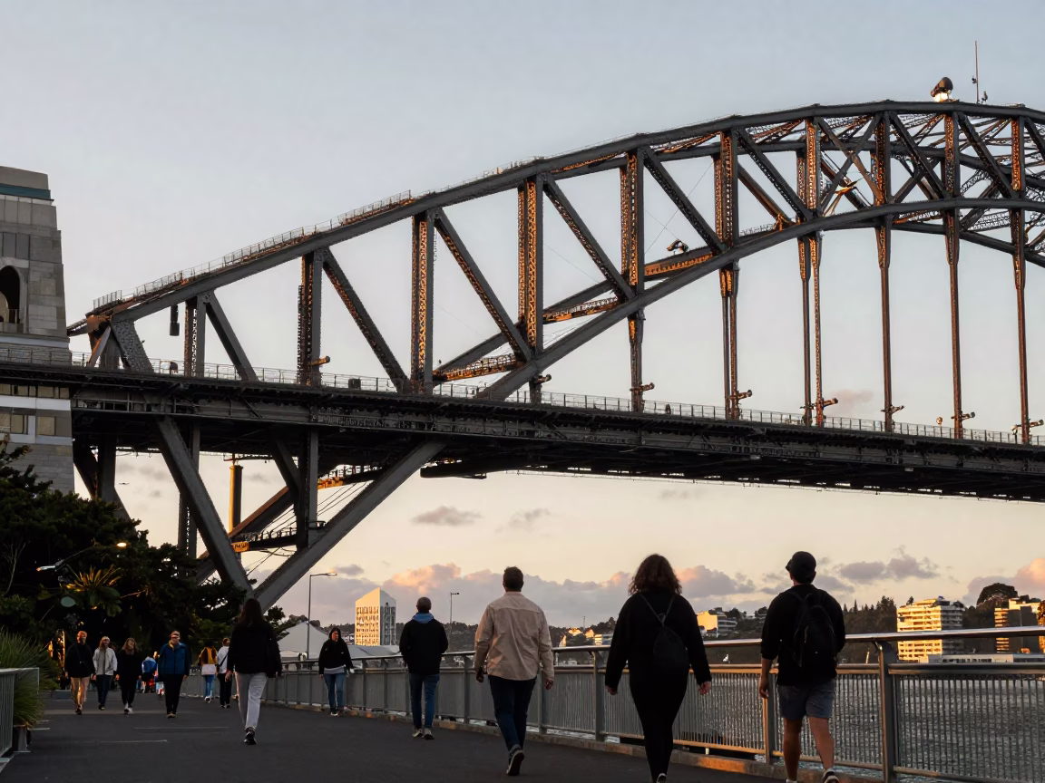Honeyed Evening Light on Auckland Harbour Bridge Walkway with Pedestrians and City Skyline in in Auckland, New Zealand