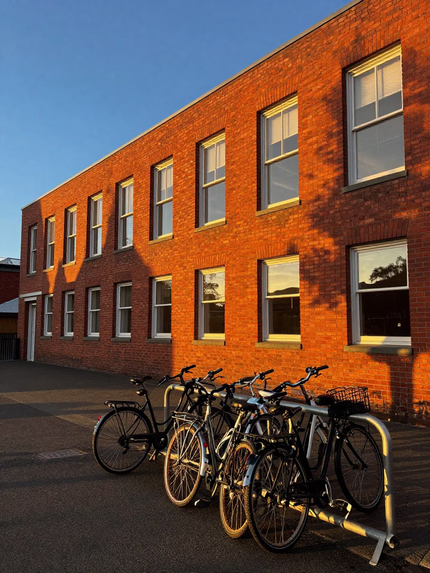 Honeyed Evening Light on Christchurch Red Brick Lecture Building and Bicycle Rack in in Christchurch, New Zealand