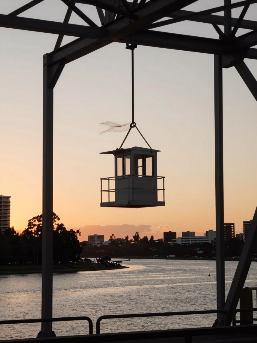 Honeyed Evening Light on Perth Bridge Maintenance Cage Swinging in Crosswind in in Perth, Western Australia, Australia