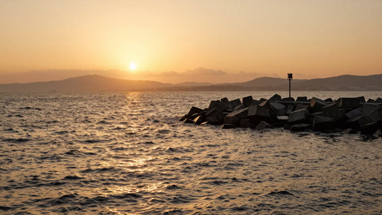 Honeyed Evening Light Over Izmir Harbor Breakwater and Lonely Beacon in in Izmir, Turkey
