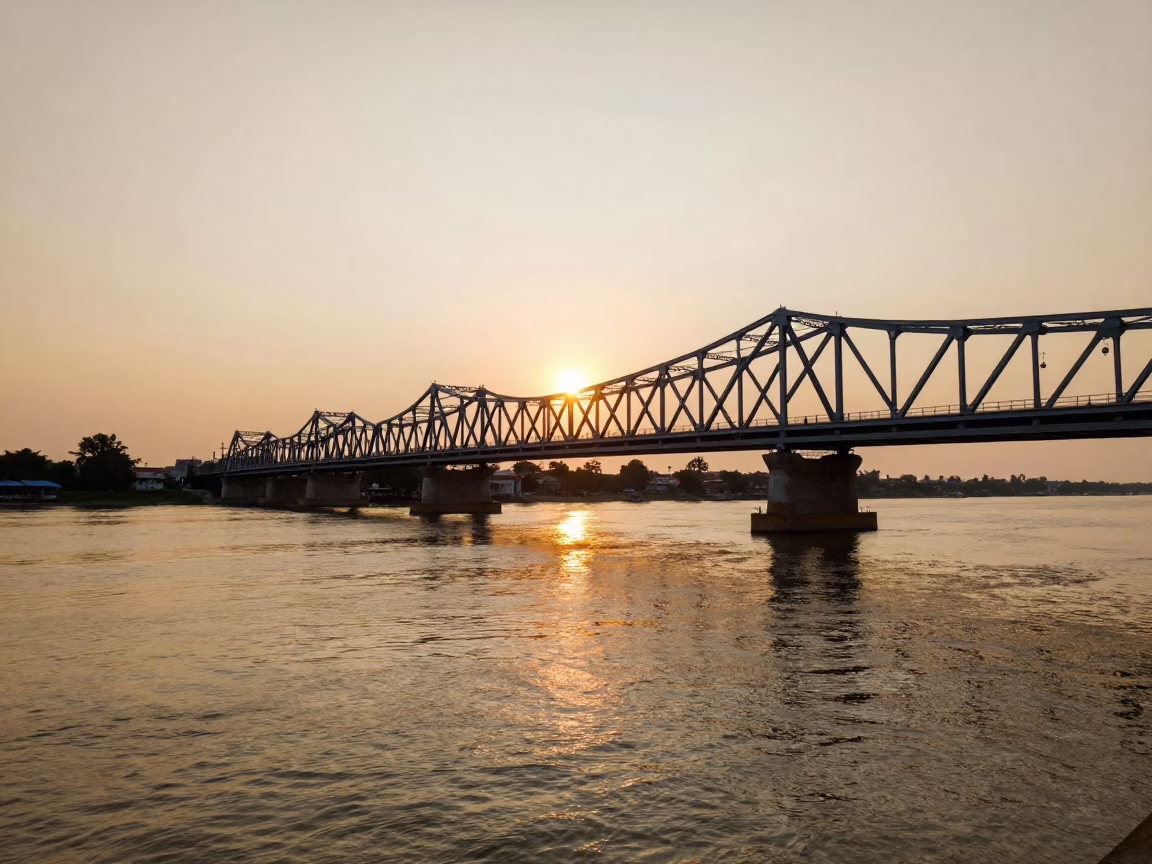 Honeyed Evening Light Over Phnom Penh Mekong River Viaduct and Traditional Boats in in Phnom Penh, Cambodia