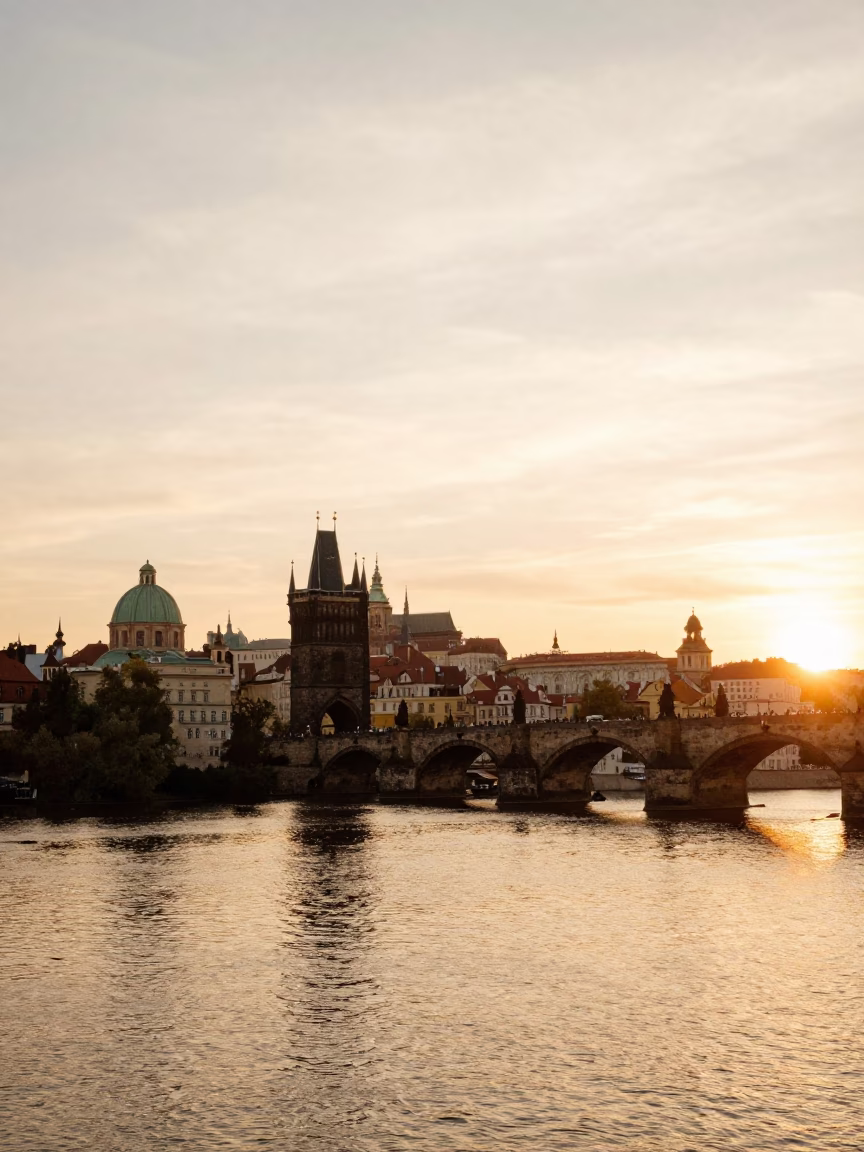 Honeyed Evening Light Over Prague Vltava River and Charles Bridge Stone Architecture in in Prague, Czech Republic