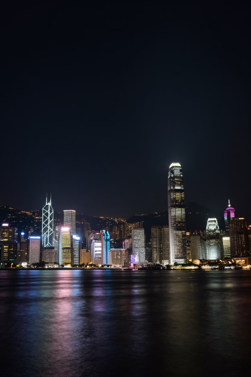 Hong Kong Night Skyline and Harbor Reflections Under Deep Darkness in in Hong Kong, Hong Kong