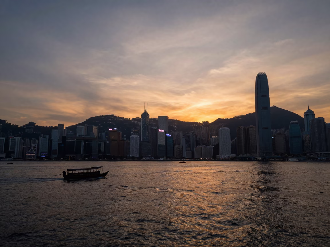 Hong Kong Sunset Over Kowloon Waterfront with Fishing Prau and Urban Skyline in in Hong Kong, Hong Kong