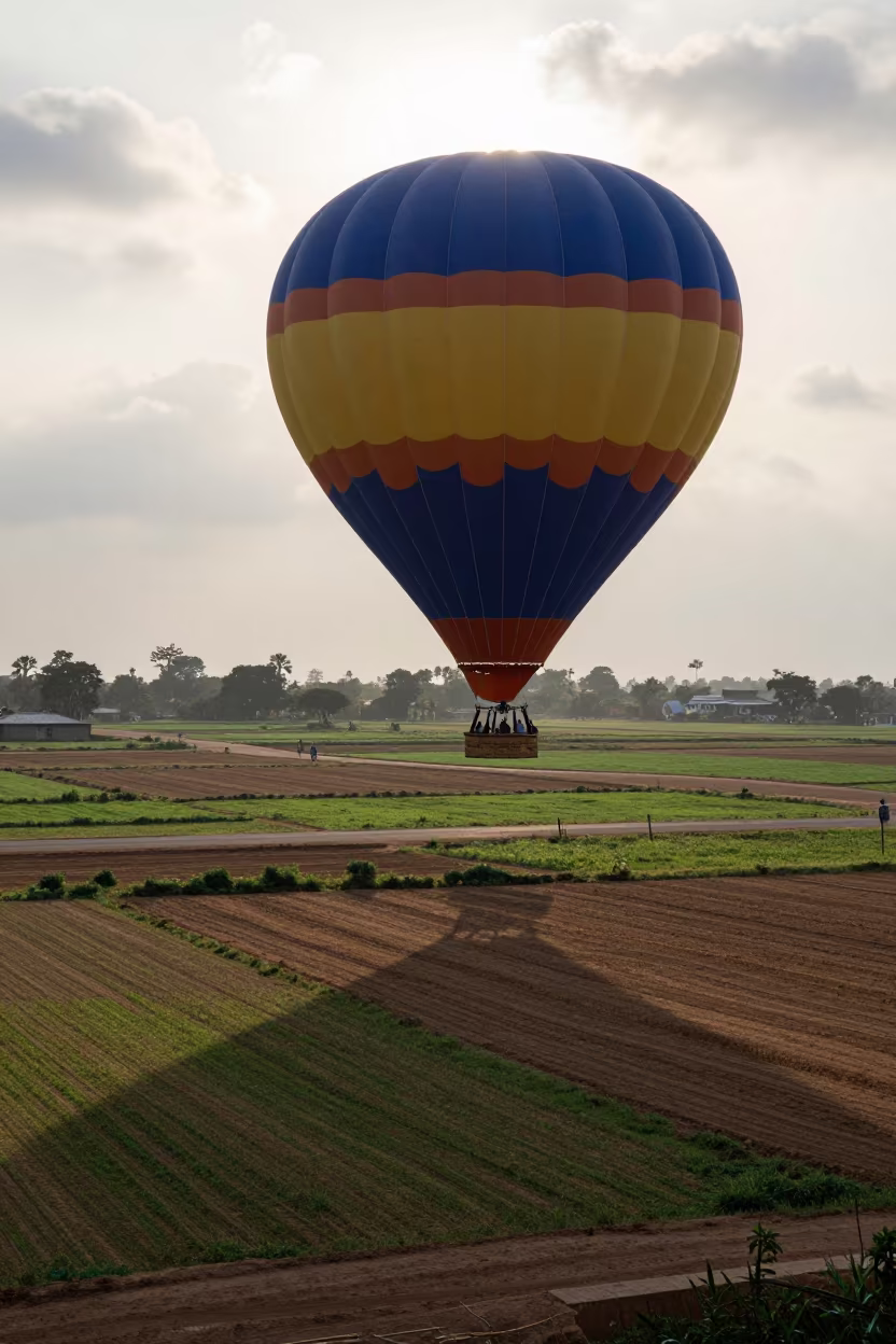Hot Air Balloon Shadow Over Kaduna Patchwork Fields in on a wind-open causeway near Kaduna