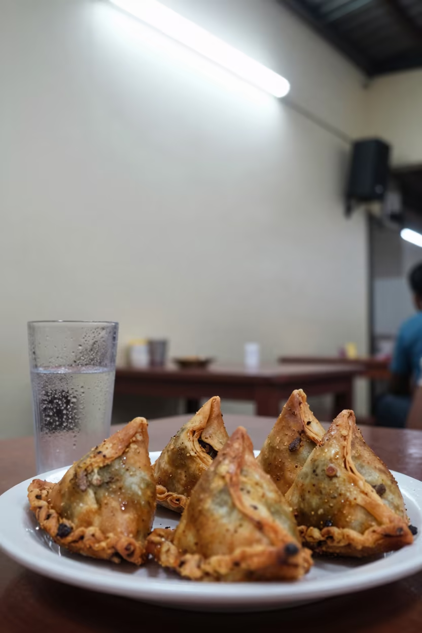 Hot Spiced Meat Sambusas on Diner Tray in at a roadside diner table in Hyderabad
