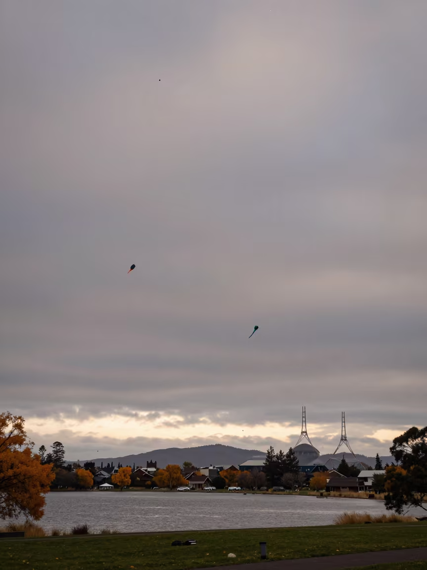Hundreds of Kites Over Canberra Waterfront at Dawn in at a waterfront celebration near Canberra