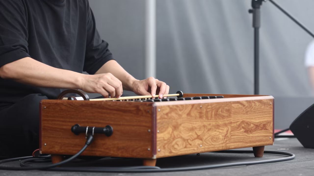 Hurdy-Gurdy Player Cranking Drone at Daejeon Fair in on a festival main stage in Daejeon