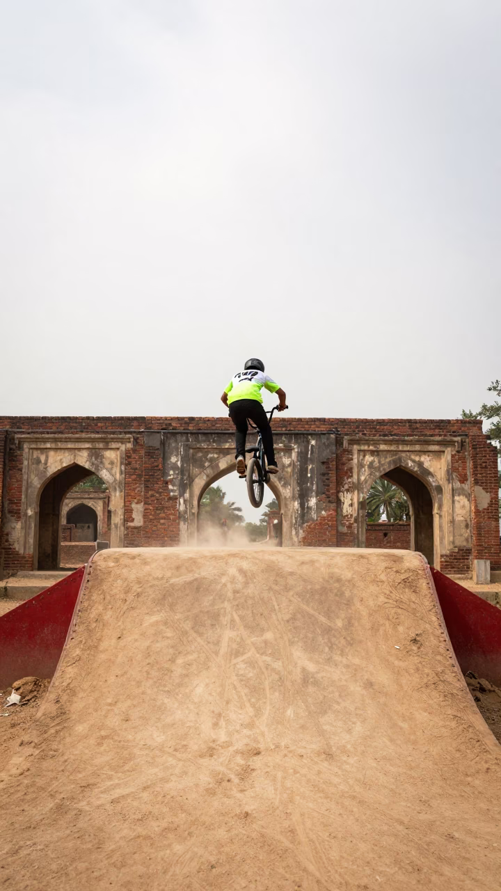 Hyderabad BMX Rider Mid Air Over Dirt Ramp in in the old quarter in Hyderabad
