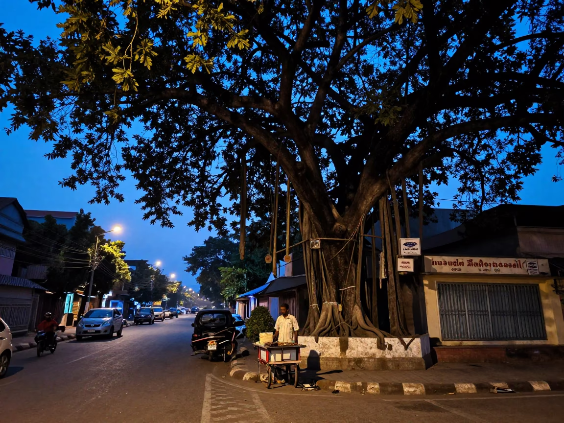 Hyderabad India Indigo Twilight Street Scene with Banyan Tree and Local Interaction in in Hyderabad, India