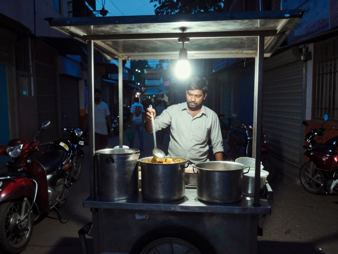 Hyderabad street food vendor midnight stall with steel vessels and serving spoons in in Hyderabad, India