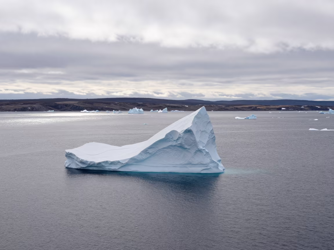 Iceberg Arch Floats in Quebec Valley Thaw in across a wide valley floor in Quebec