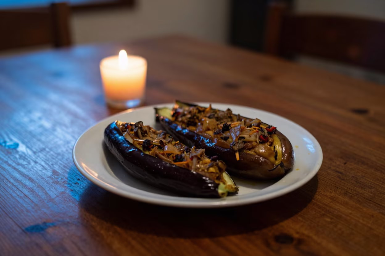 Imam Bayildi Eggplant in Lokoja Candlelight in on a rustic wooden table in Lokoja