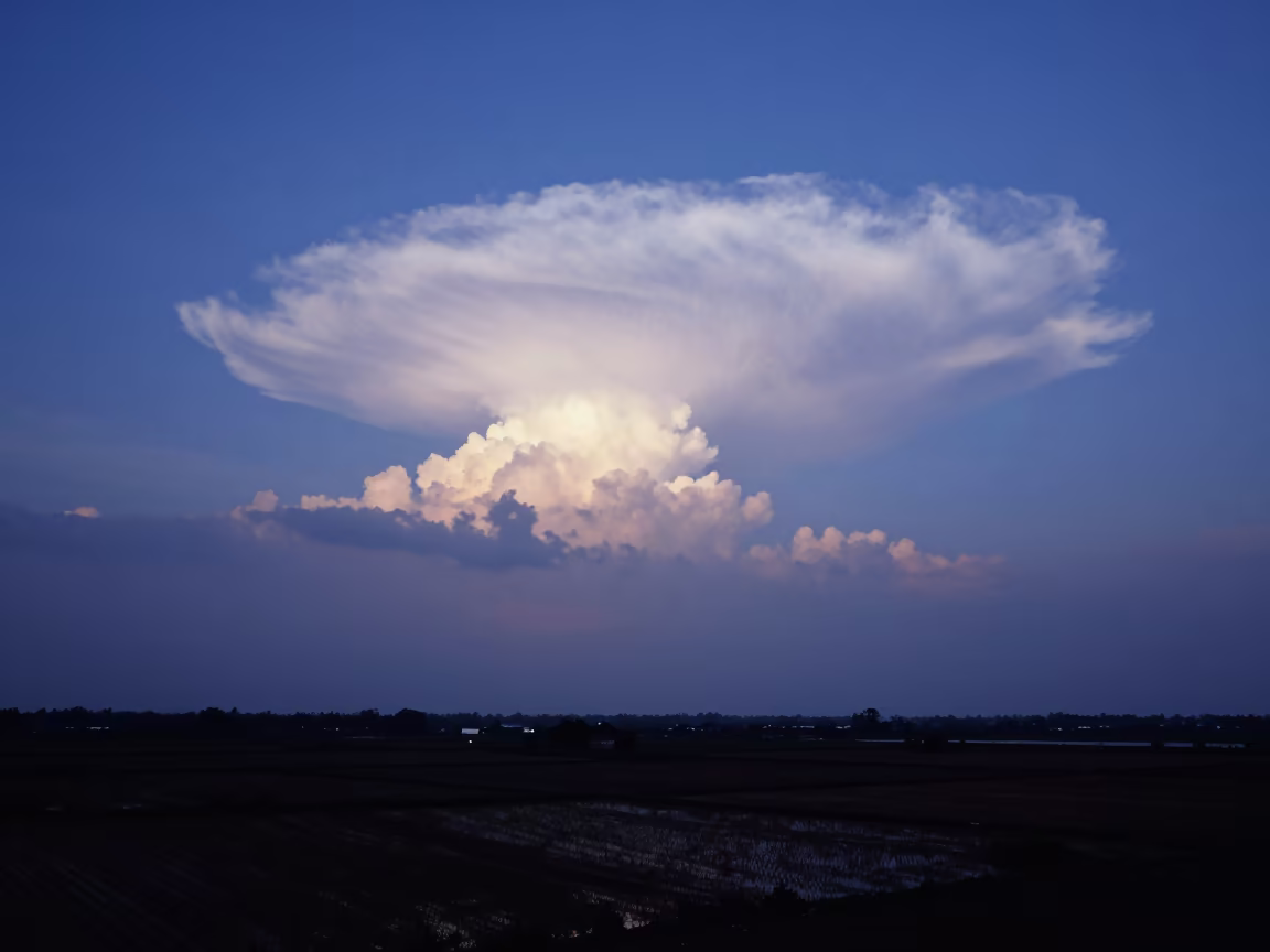 Indigo Kelvin-Helmholtz Clouds Over Can Tho Plain in across a storm-bright plain near Can Tho