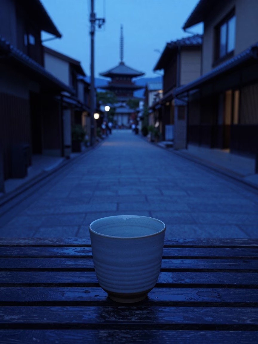 Indigo Twilight Kyoto Street Scene with Ceramic Cup and Grease Sheen on Wooden Bench in in Kyoto, Japan