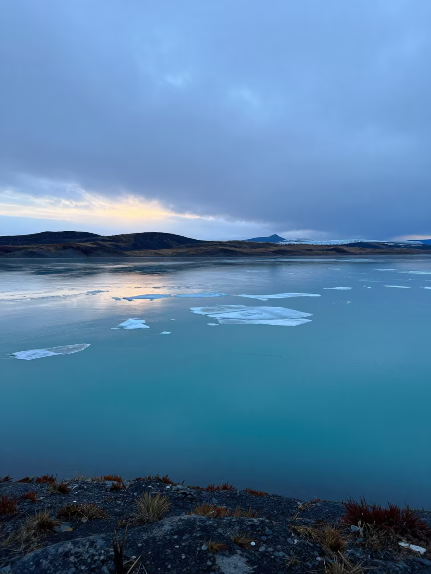 Indigo Twilight Lake with Floating Ice Chunks in across a floodplain after rain in Northwest Territories