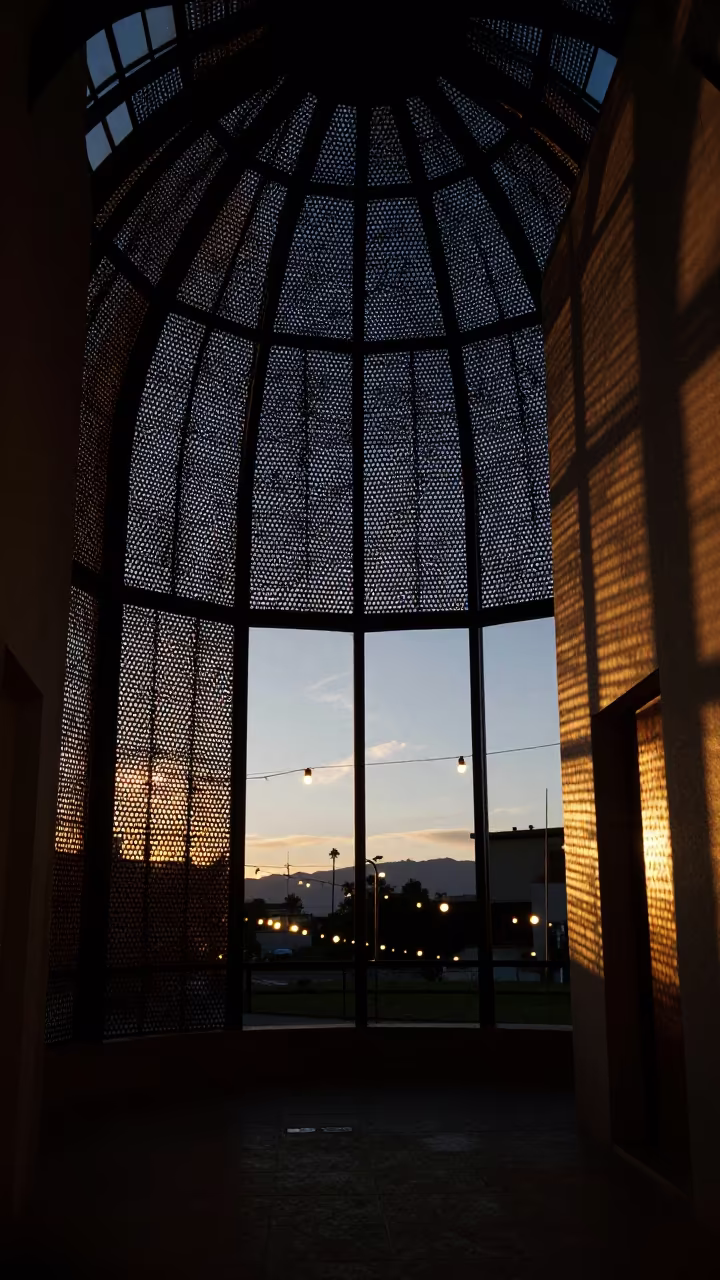 Indigo Twilight Light Through Perforated Metal Screen in inside a vaulted atrium in Cali