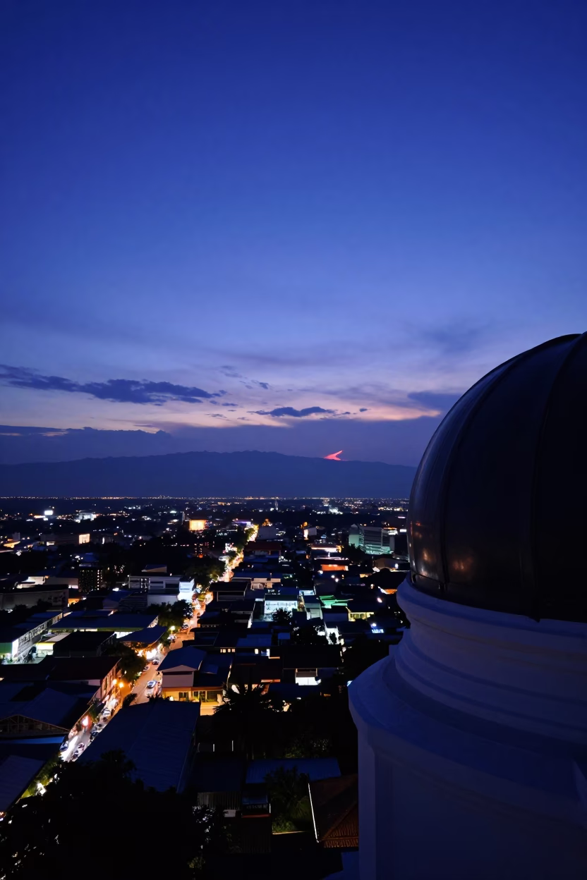 Indigo Twilight Over Chiang Mai Cityscape with Silhouetted Observatory Dome and Distant Streetlights in in Chiang Mai, Thailand