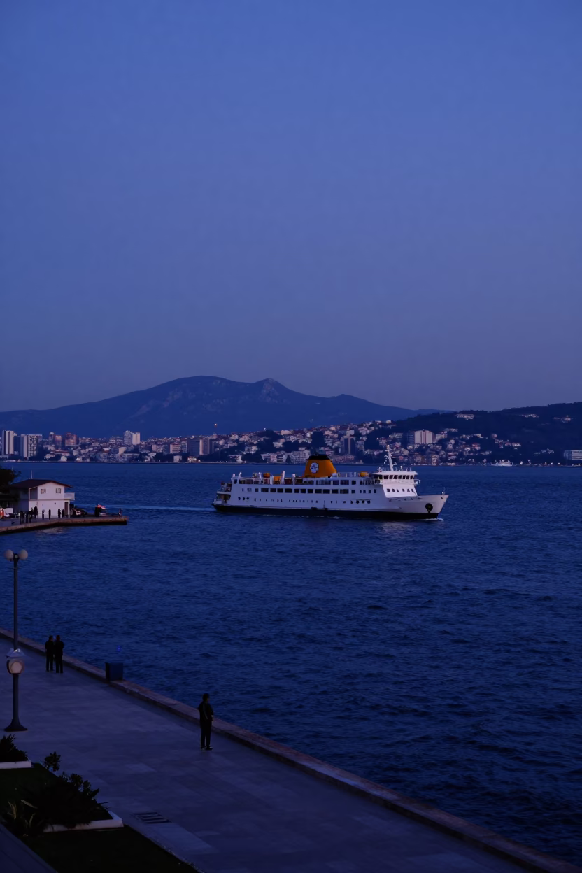 Indigo Twilight Over Izmir Harbor with Ferry Leaving Mountains Behind in in Izmir, Turkey