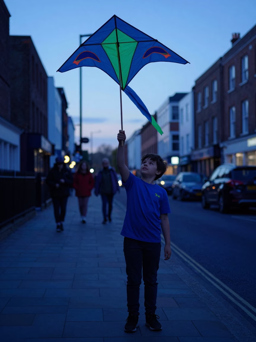 Indigo Twilight Street Photography of Bristol Boy Holding Homemade Kite Near Train Trestle in in Bristol, United Kingdom