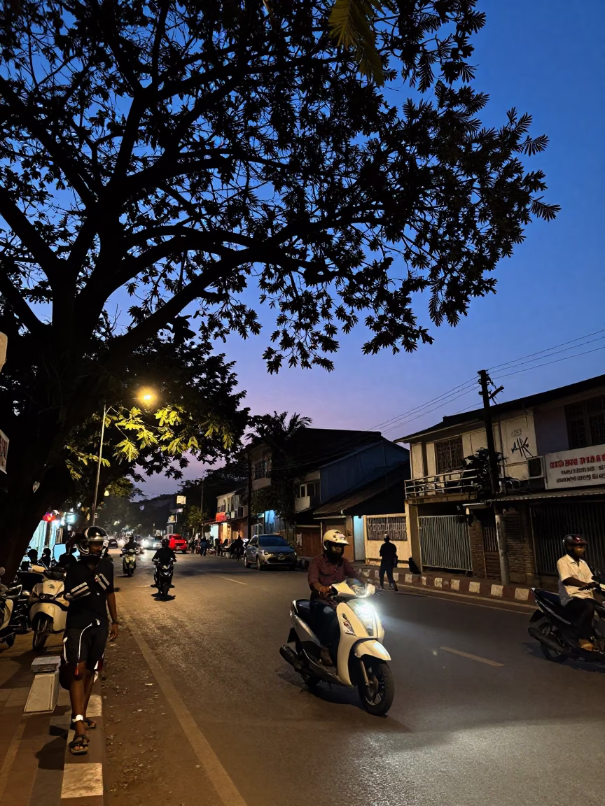 Indigo Twilight Street Scene in Hyderabad India with Motorbike and Street Vendor in in Hyderabad, India