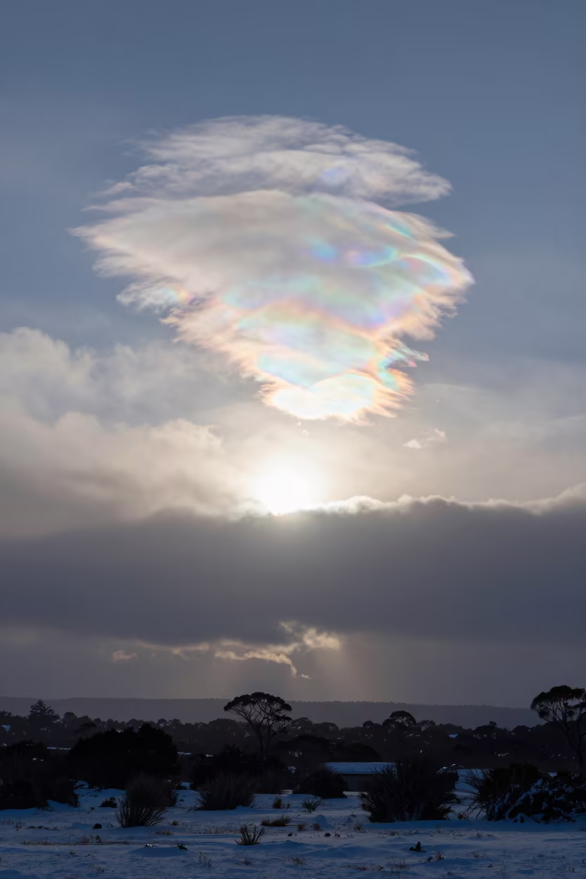 Iridescent Cloud Fragment Before Sunrise Tasmania in over a horizon of stacked thunderheads in Tasmania