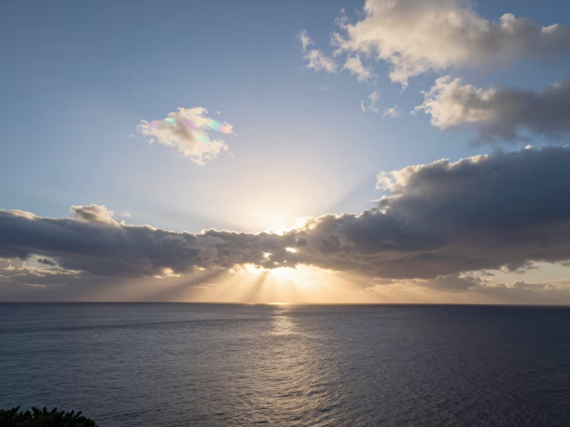 Iridescent Cloud Fragment Shimmering at Hawaii Sunrise in beneath fast-moving cloud bands in Hawaii