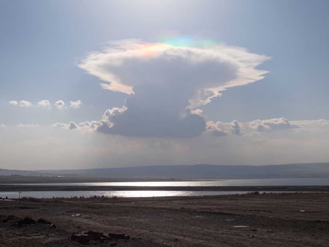 Iridescent Cloud Over Storm Bright Plain Near Kahramanmaraş in across a storm-bright plain near Kahramanmaraş